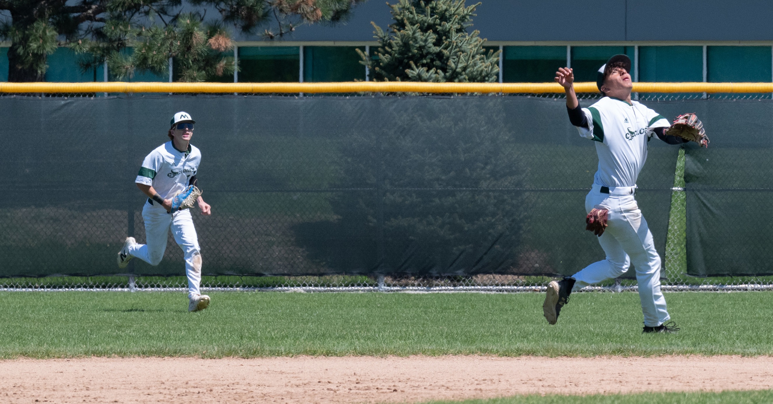 Moraine Valley baseball players field a fly ball.