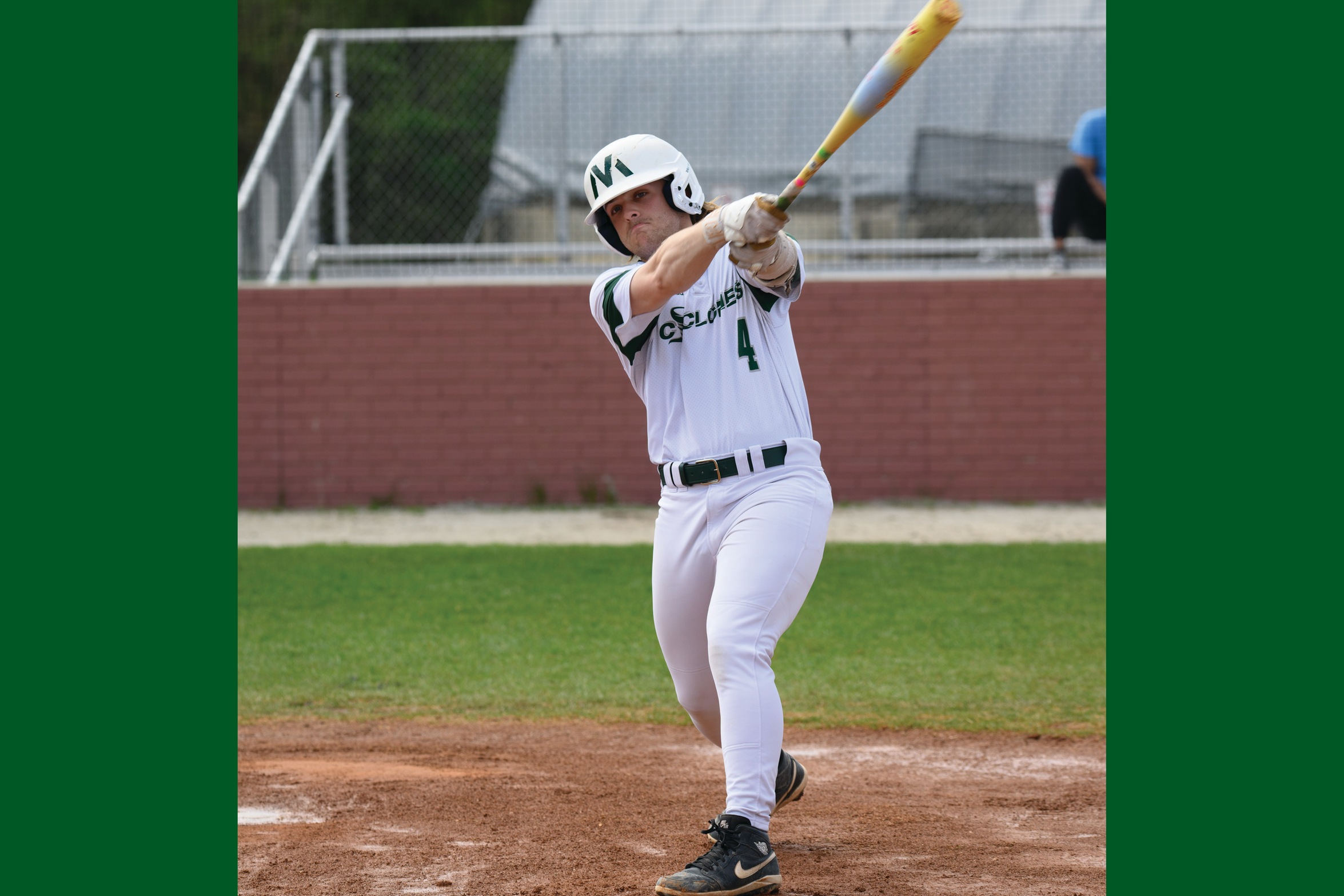 A Moraine Valley baseball batter swings the bat.