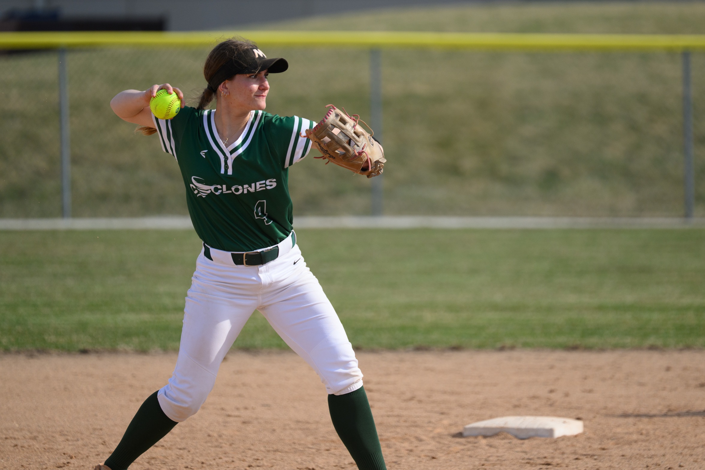 A Moraine Valley infielder gets ready to throw the ball to first base.