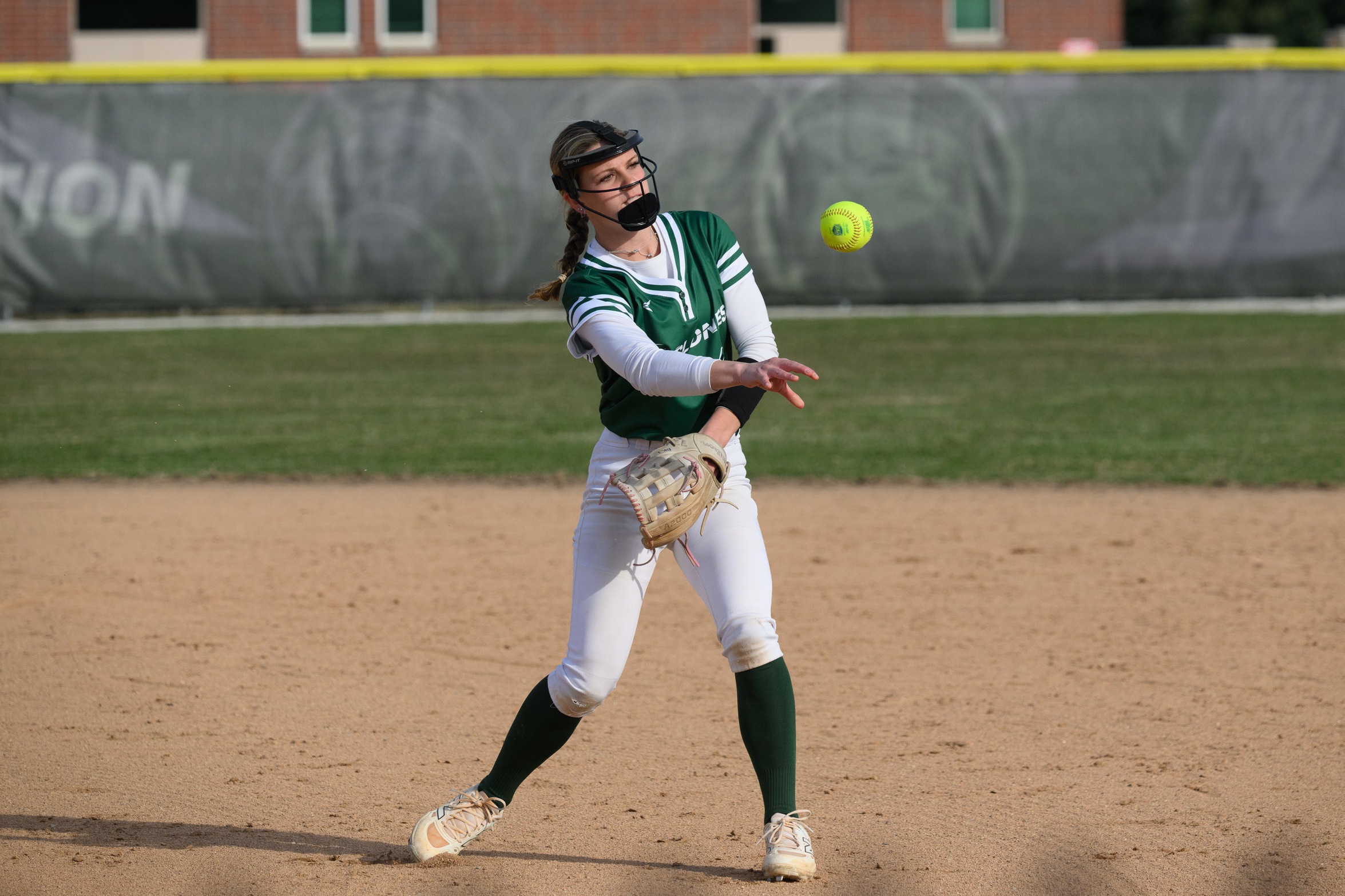 A Moraine Valley softball player throws the ball.