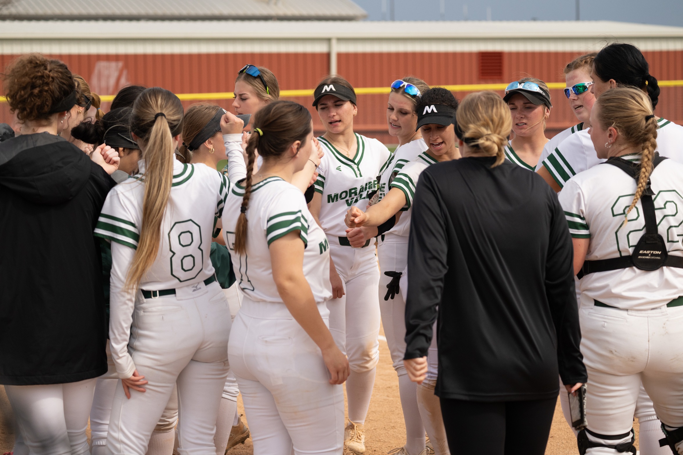The Moraine Valley softball team gathers together for a hands-in.