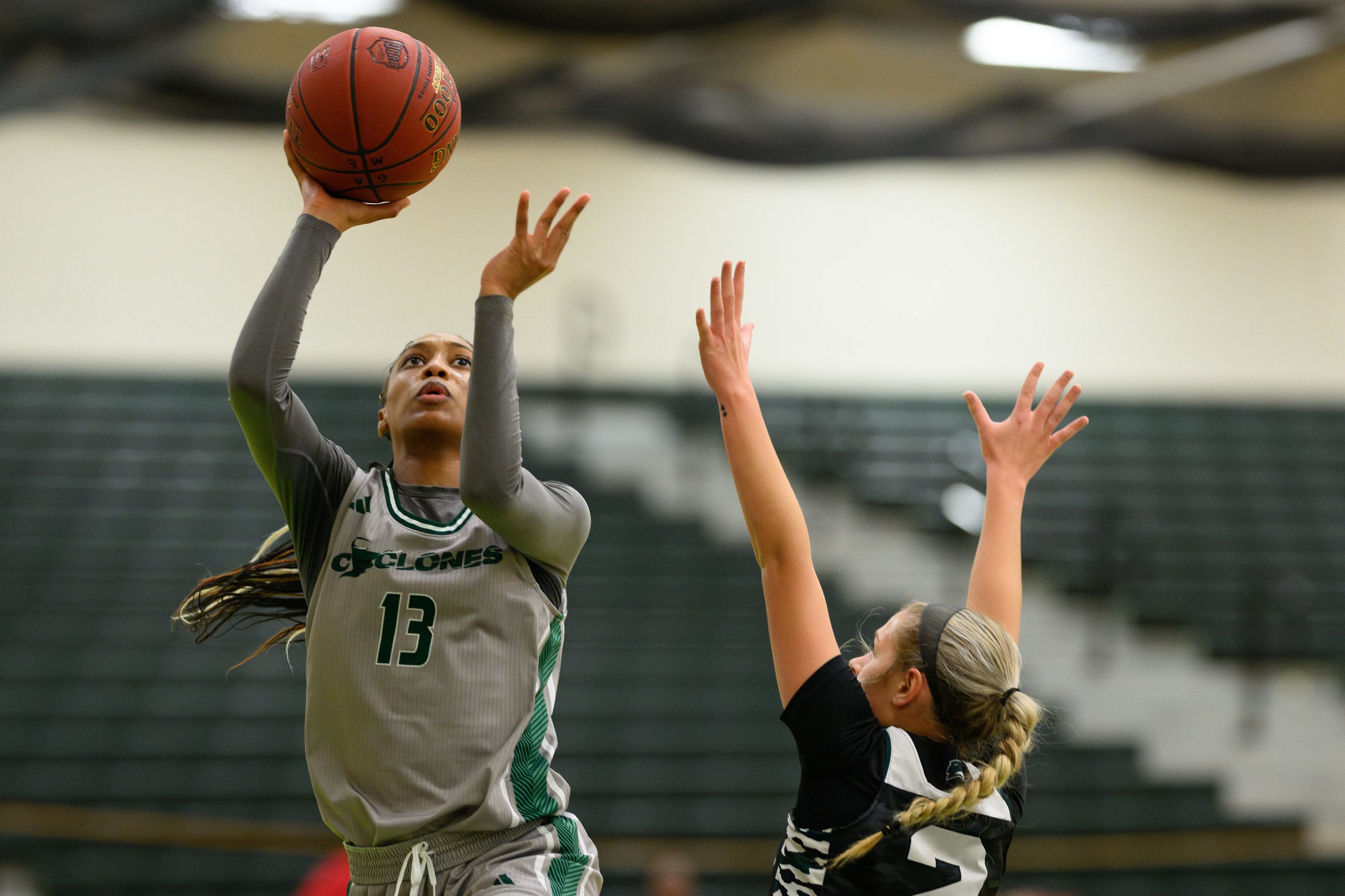 Basketball player Jadea Johnson scoring a layup.