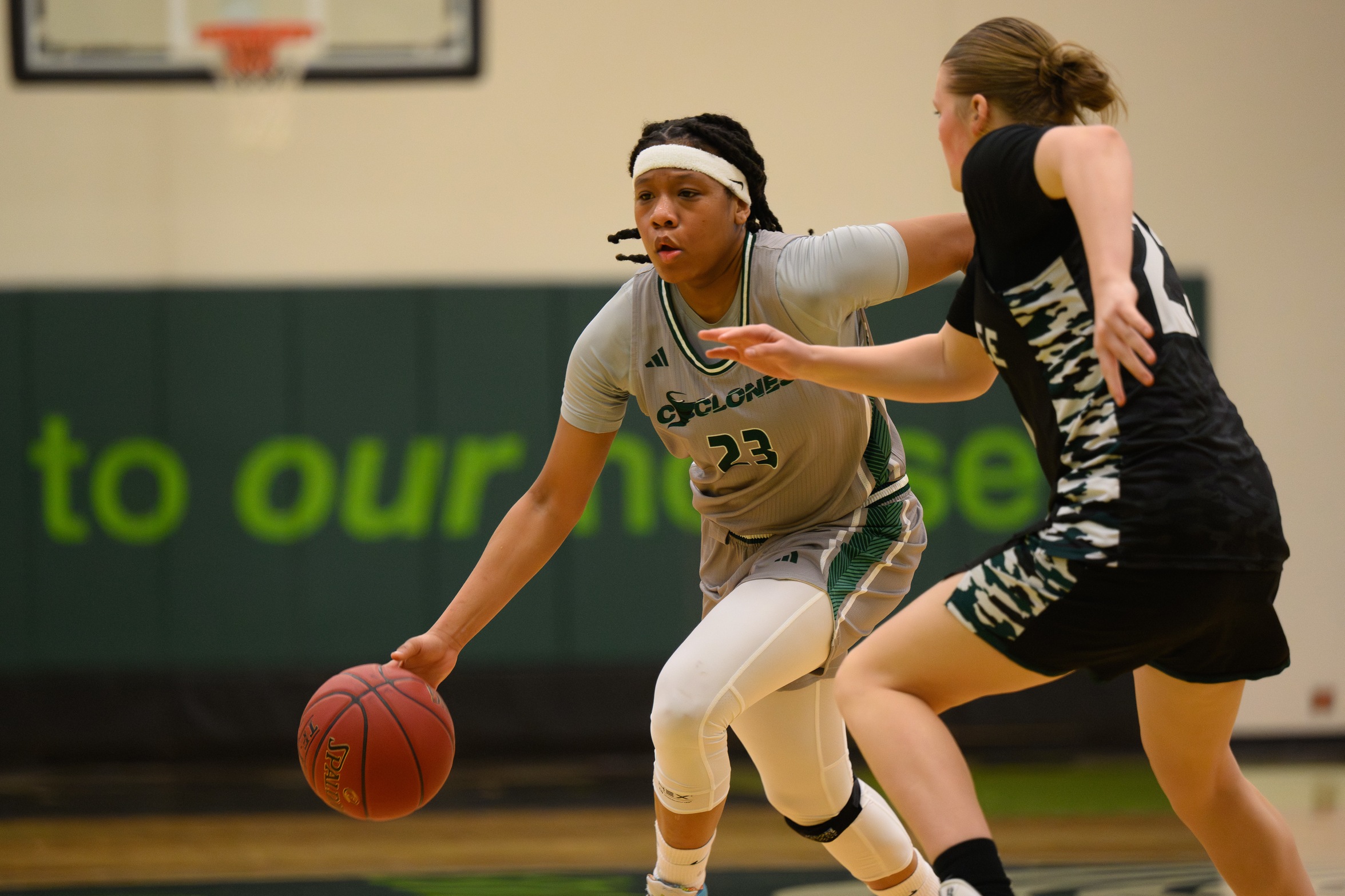 Basketball player Shakila Brownlow dribbles the ball.